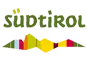 Südtirol-Logo mit grünem Schriftzug und einem stilisierten Profil der Südtiroler Berge in lebhaften Farben.